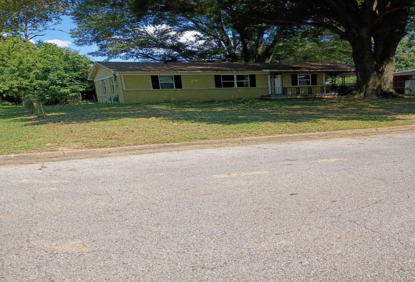 Single story home featuring a front lawn and covered porch