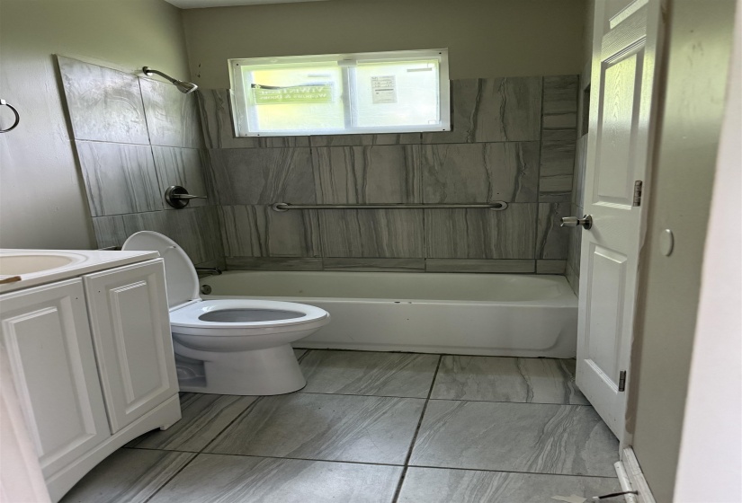 Full bath with plenty of natural light, vanity, and shower / bathtub combination