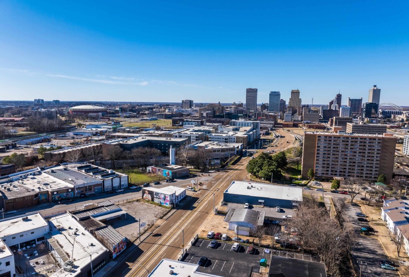 Aerial view of property's location featuring industrial structures and nearby urban area