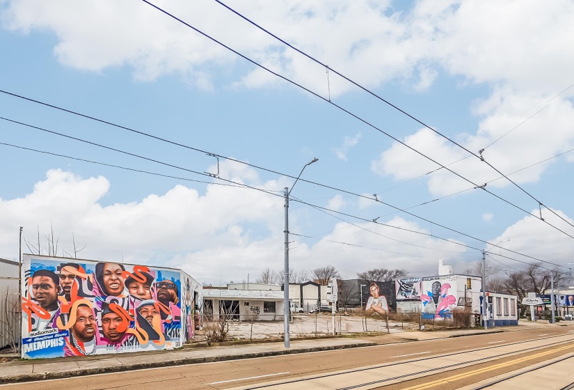 View of road featuring curbs, street lights, and sidewalks