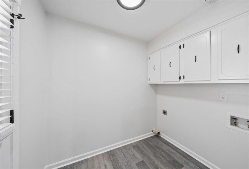 Laundry room with cabinet space, dark wood-type flooring, electric dryer hookup, and hookup for a washing machine
