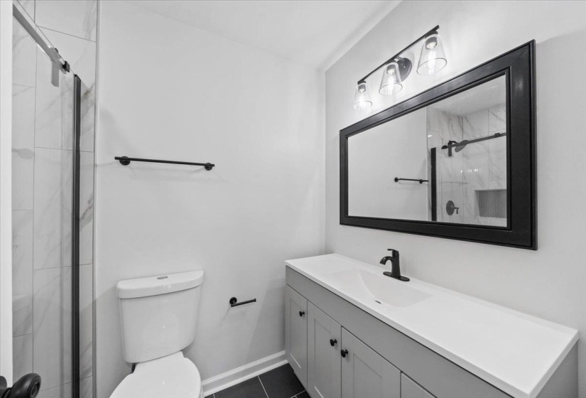 Full bathroom with a shower stall and vanity