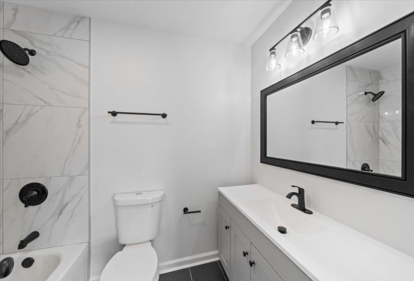 Bathroom featuring bathtub / shower combination and vanity