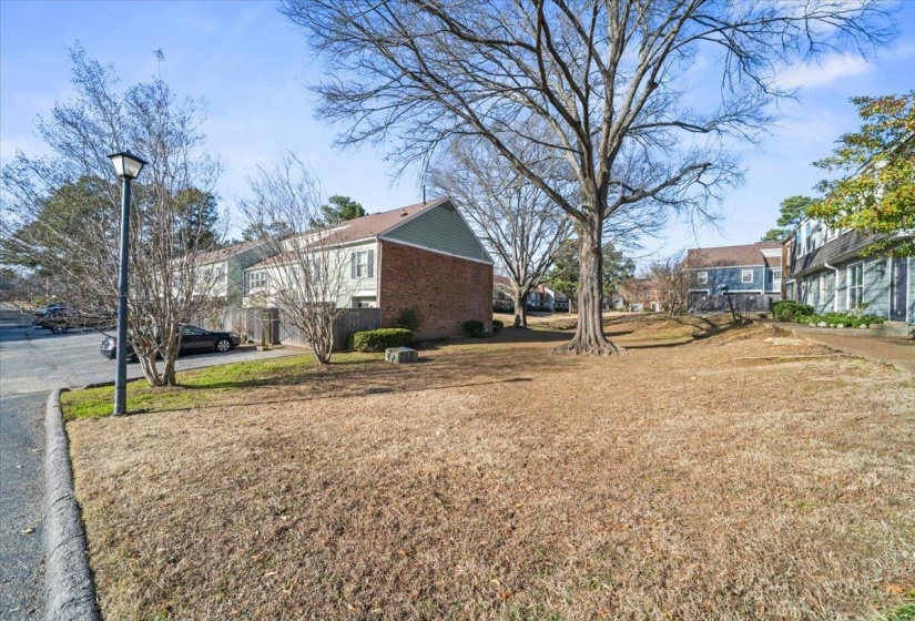 View of side of home featuring a yard and a residential view