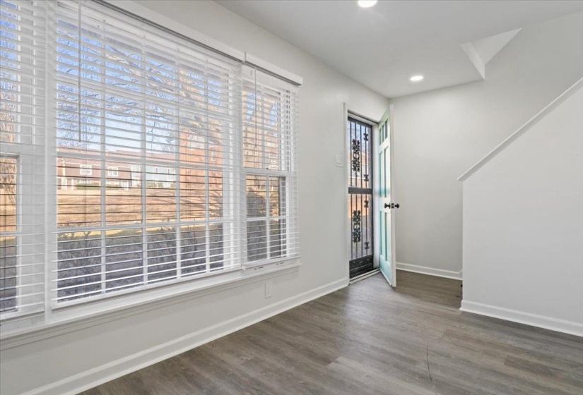 Entryway with dark wood-style flooring and recessed lighting