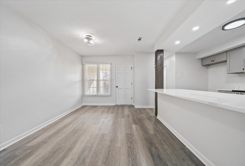 Unfurnished dining area featuring dark wood-style flooring and recessed lighting