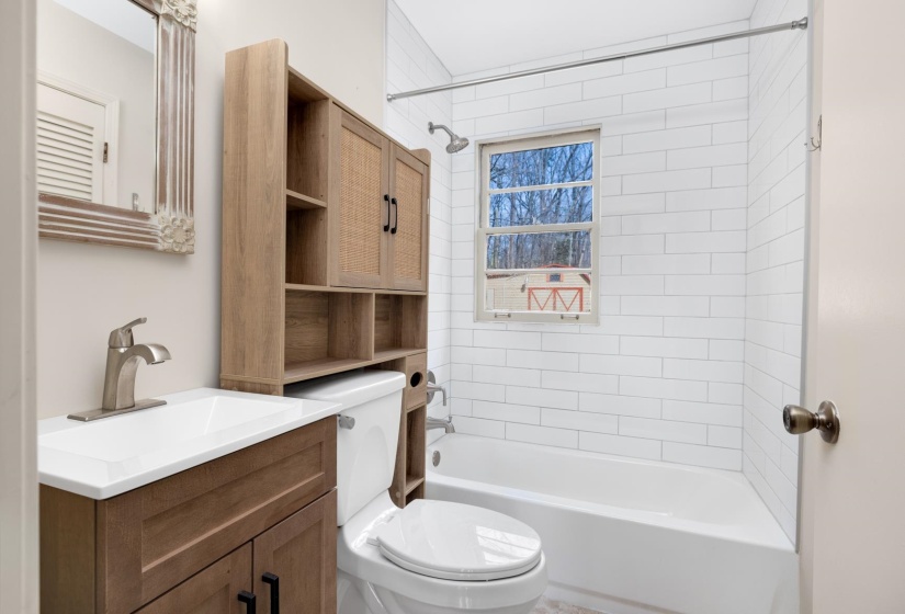 Bathroom featuring tub / shower combination and vanity