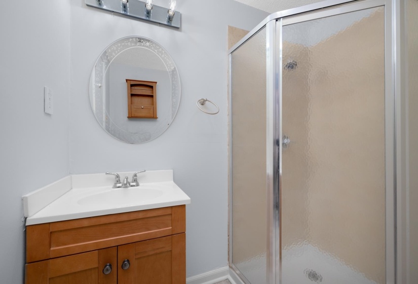 Full bath with vanity and a stall shower