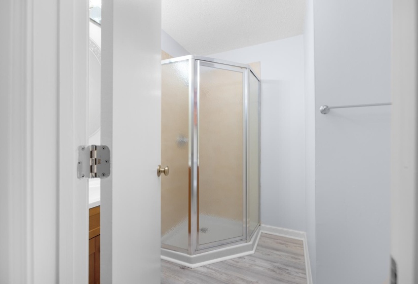 Bathroom featuring vanity, a shower stall, and light wood-type flooring