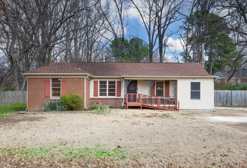 Ranch-style house with roof with shingles, brick siding, and a wooden deck