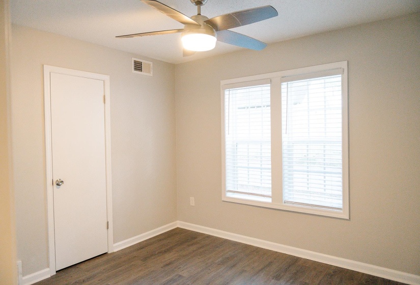 Spare room featuring ceiling fan and dark hardwood / wood-style floors