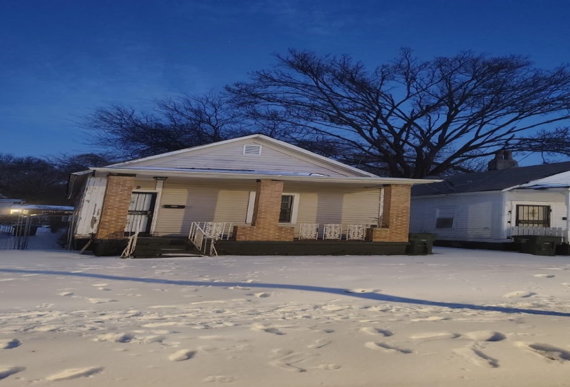 View of front facade with covered porch and brick siding