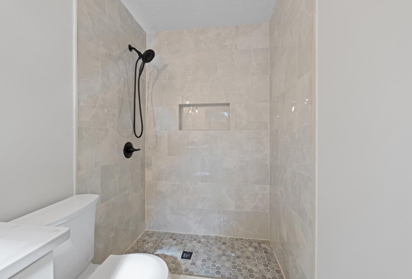 Bathroom featuring a shower stall and vanity