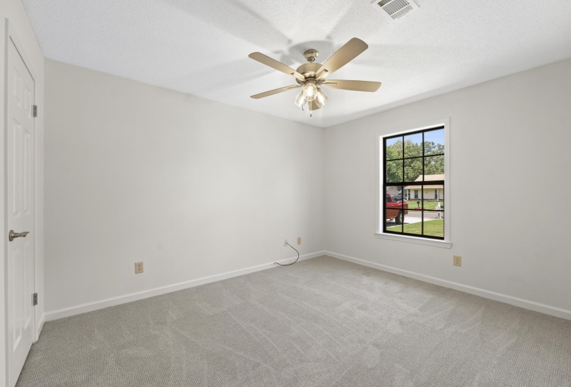 Unfurnished bedroom featuring light colored carpet and a ceiling fan