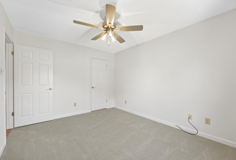 Unfurnished bedroom featuring carpet floors and a ceiling fan