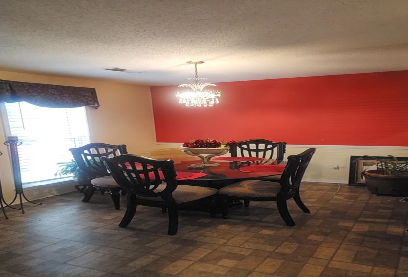 Dining room with a chandelier and a textured ceiling