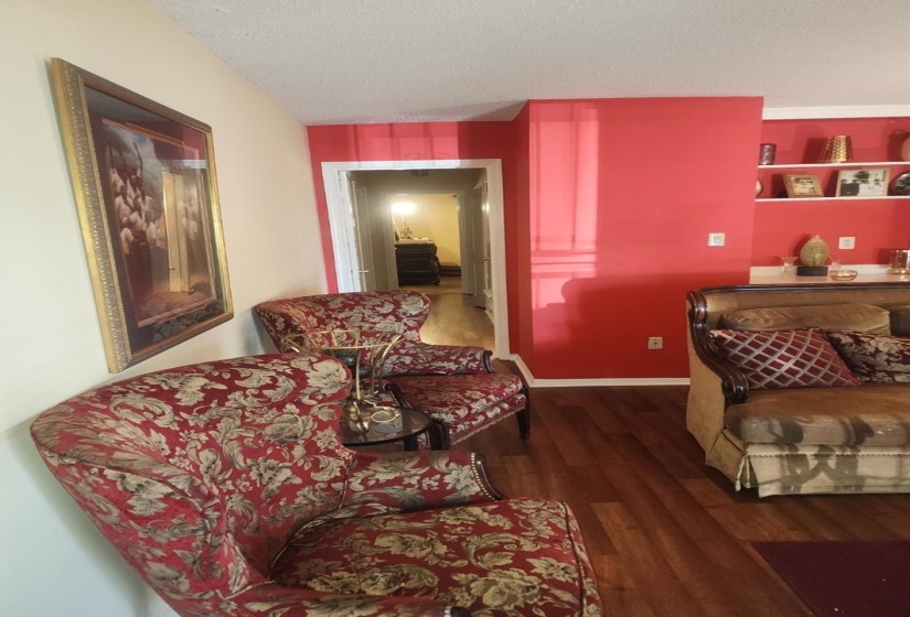 Bedroom with dark wood finished floors and baseboards