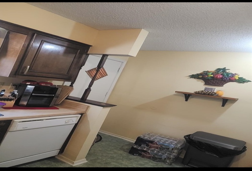 Office with a textured ceiling and baseboards