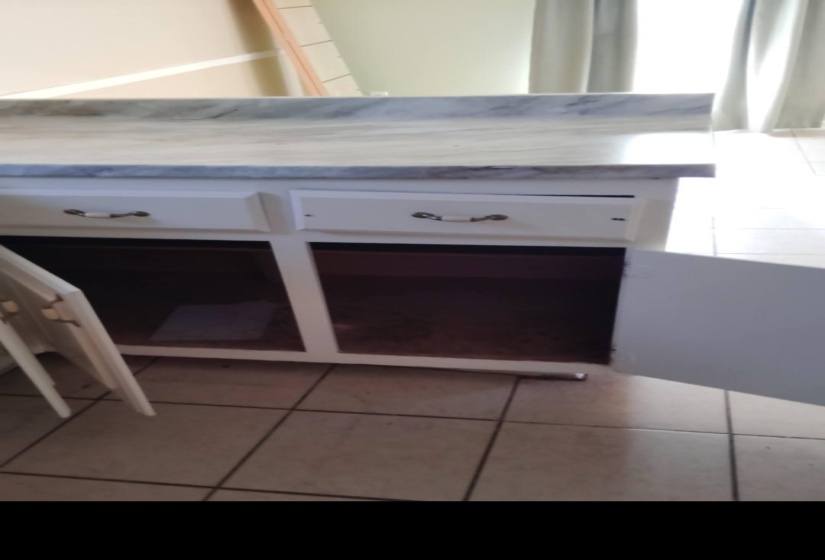 Detailed view of white cabinetry and light countertops
