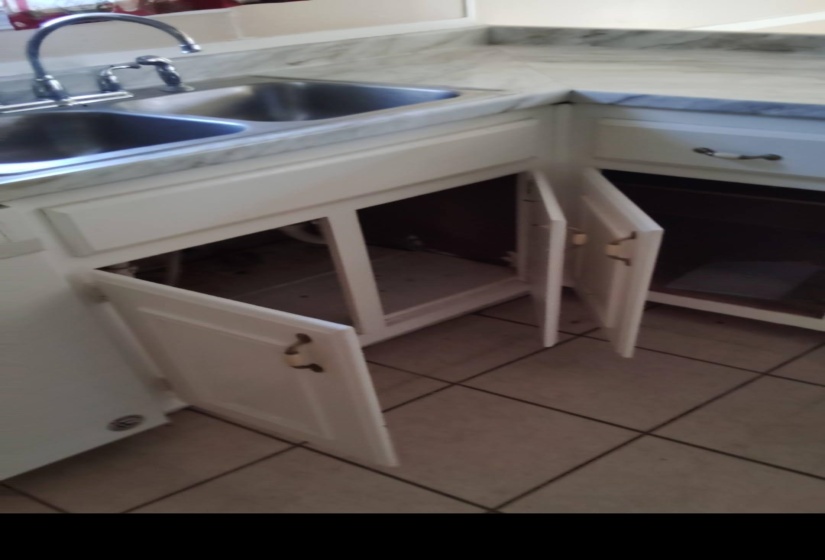Kitchen view of white cabinets and light countertops