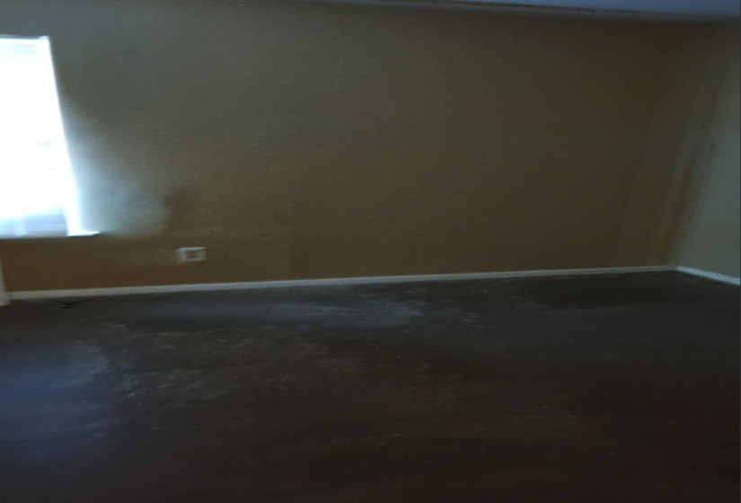 Unfurnished room with baseboards and dark carpet