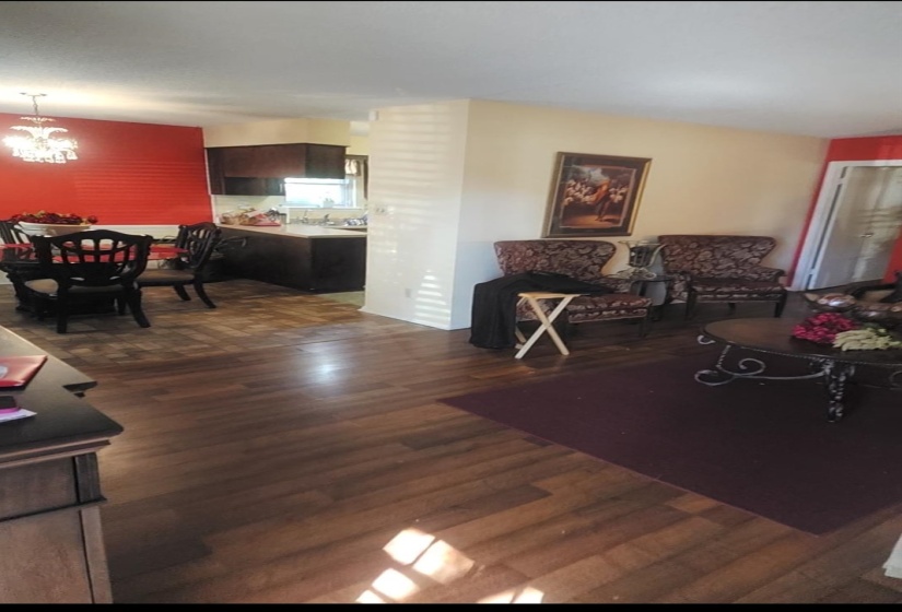 Living room featuring dark wood finished floors and a chandelier