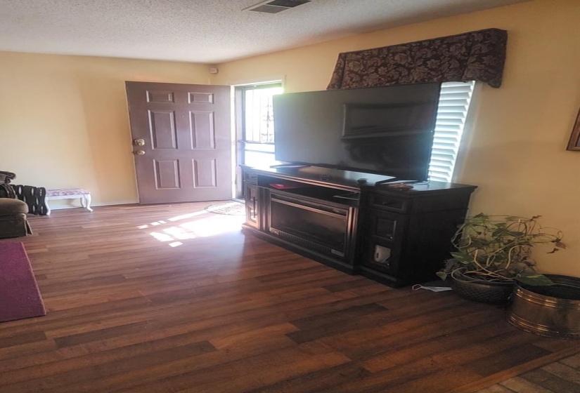 Foyer featuring a textured ceiling and dark wood-style flooring