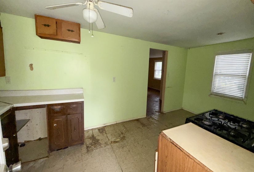 Kitchen area featuring a built-in cooktop, existing cabinetry, and a ceiling fan