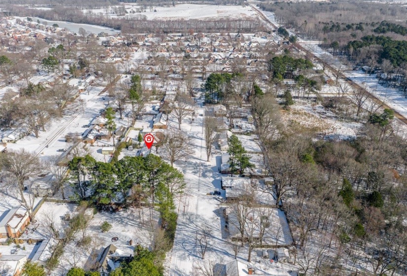 Aerial overview of property's location with nearby suburban area