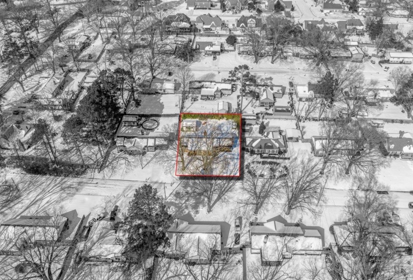 Aerial perspective of suburban area featuring property boundaries highlighted