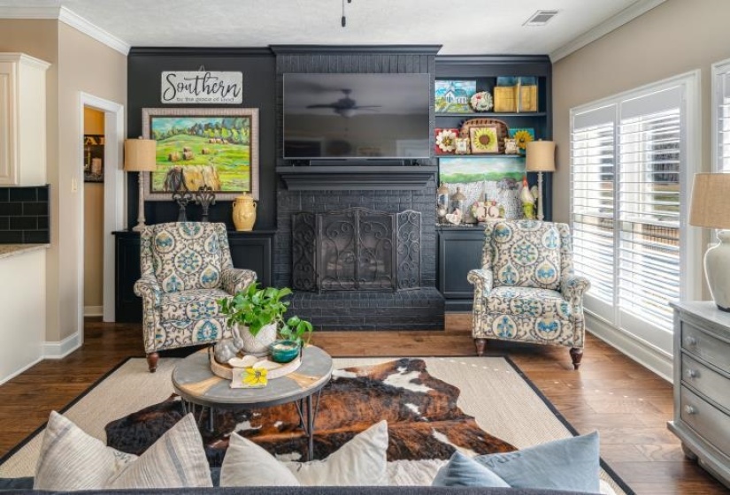 Interior space featuring a wealth of natural light, visible vents, crown molding, and wood finished floors