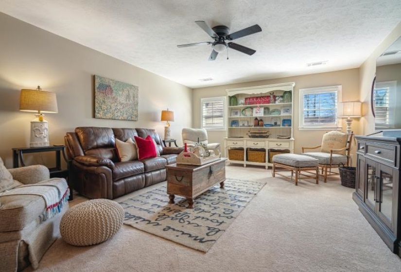 Play room with a textured ceiling, a wealth of natural light, and carpet flooring