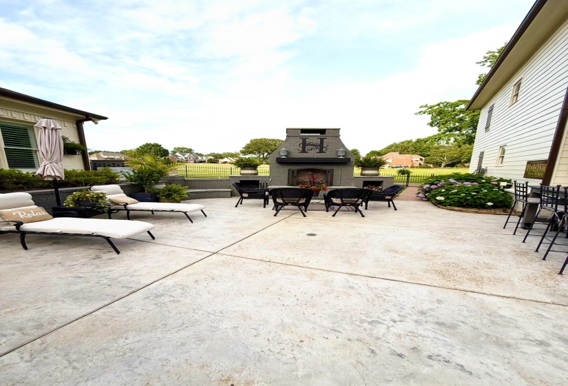 Expansive patio area including fireplace and gathering area