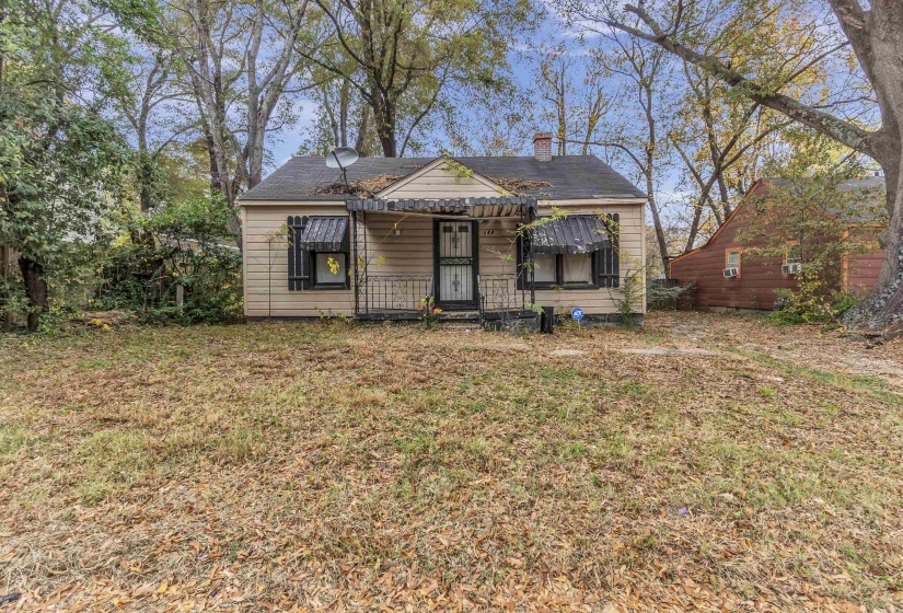 Bungalow featuring a chimney and a front yard