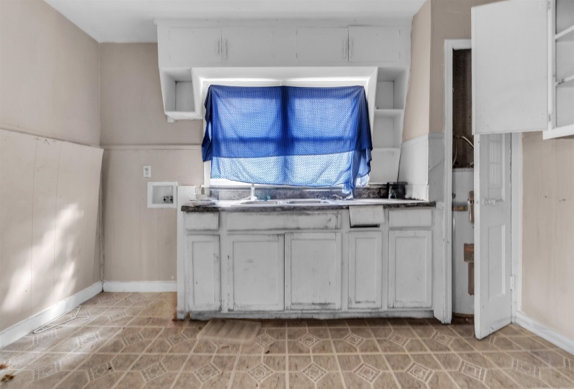 Kitchen with white cabinets and open shelves