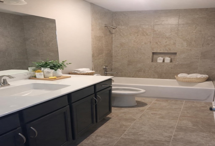 Bathroom with vanity and tub / shower combination