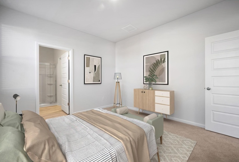 Bedroom featuring light colored carpet and ensuite bathroom
