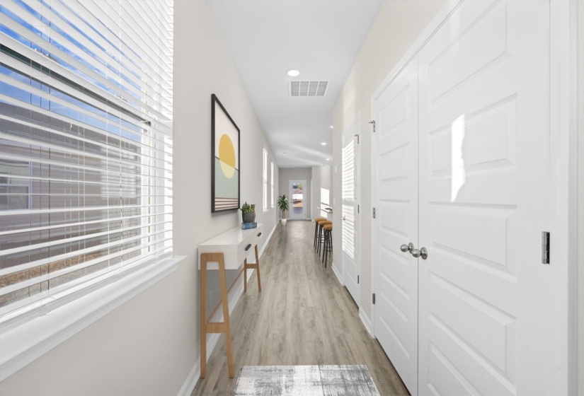 Hallway featuring light wood-style floors and recessed lighting