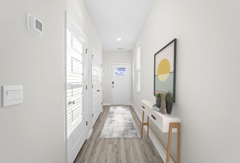 Doorway featuring wood finished floors and recessed lighting