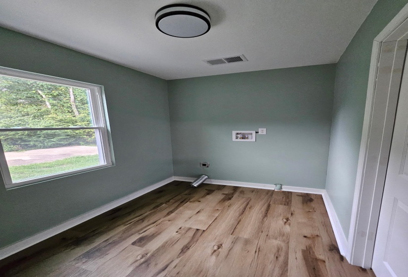 Laundry room featuring hookup for a washing machine and light wood finished floors