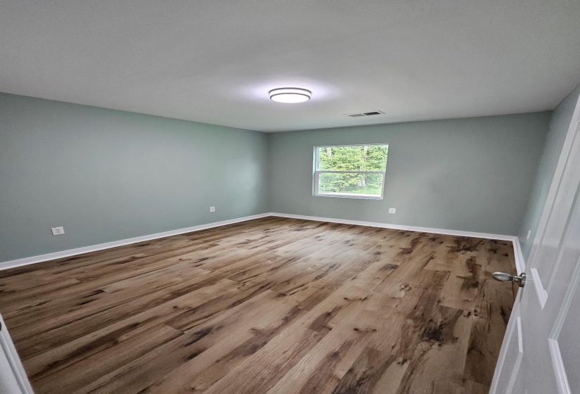 Empty room featuring wood finished floors and baseboards