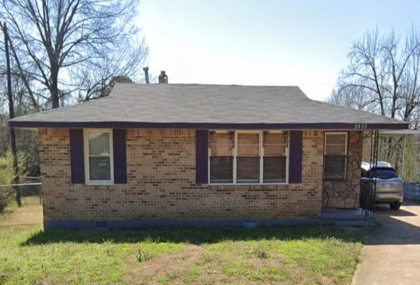 View of front of home with brick siding, crawl space, and a chimney