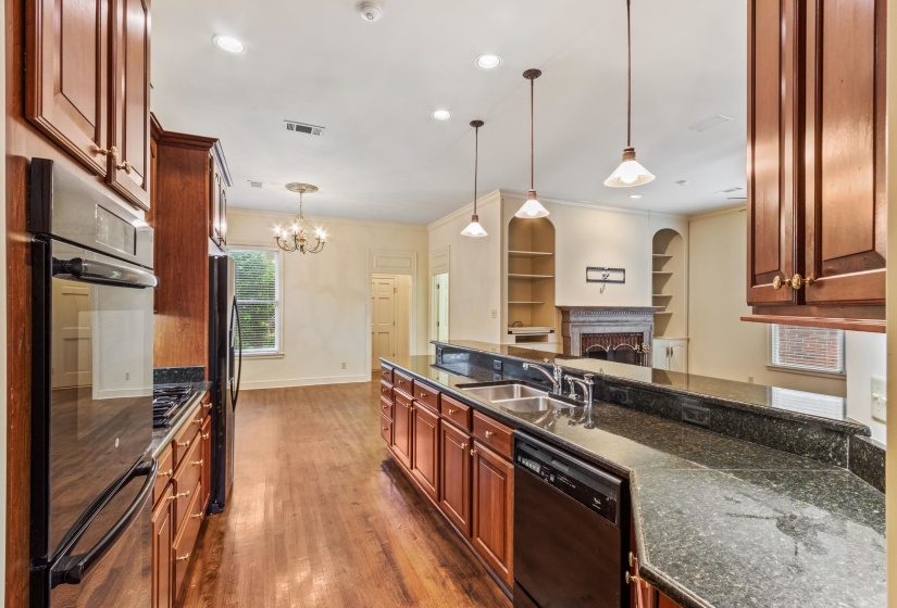 Kitchen featuring wood-finish flooring, dark wood cabinetry, and recessed lighting