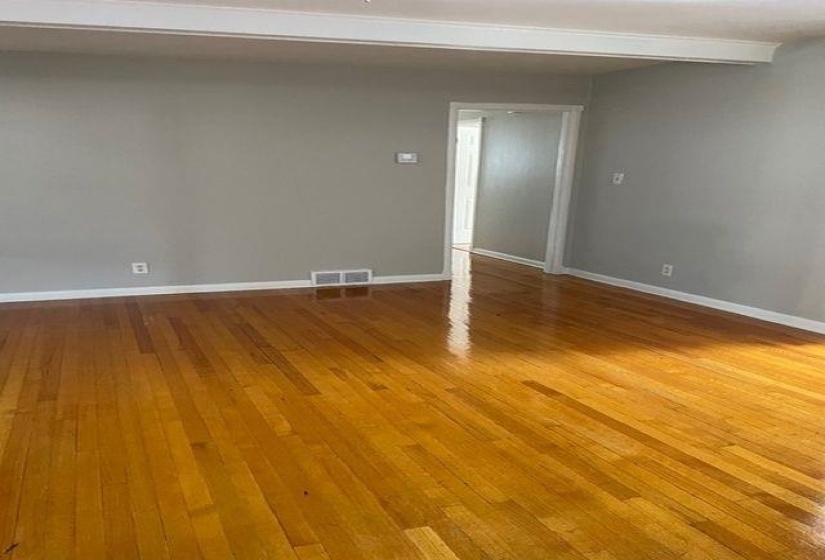 Empty room with light wood-type flooring and baseboards