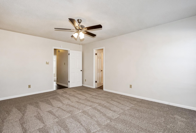 Unfurnished bedroom featuring a ceiling fan, carpet, and a textured ceiling