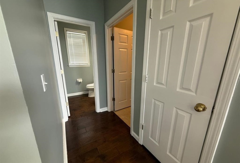Hallway featuring baseboards and dark wood-style flooring