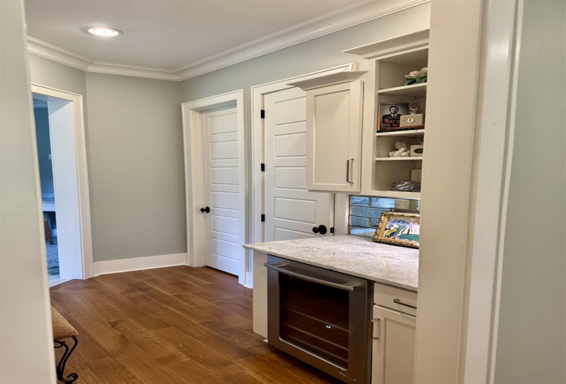 Beverage center with fridge/wine cooler     Dressing area with his & her closets and water closet