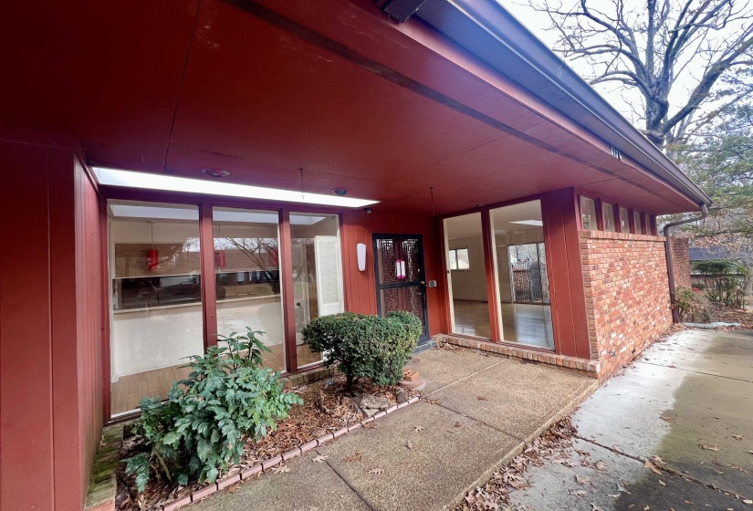 Entrance to property featuring brick siding
