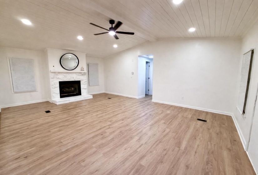 Unfurnished living room with light wood-style flooring, a high end fireplace, wood ceiling, recessed lighting, and a ceiling fan