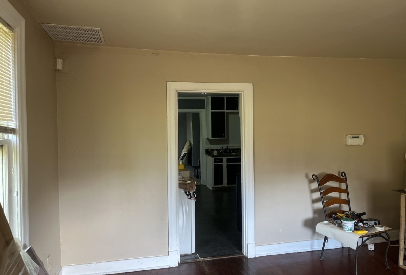 Bedroom featuring baseboards, dark wood finished floors, and visible vents